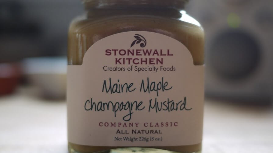 A container holding delectable mustard infused with the distinct flavor of maple.